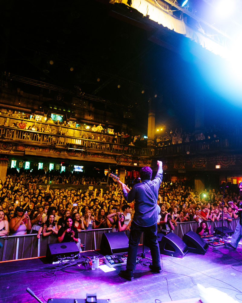 Band performing in front of a large crowd at the House of Blues in Orlando, FL.